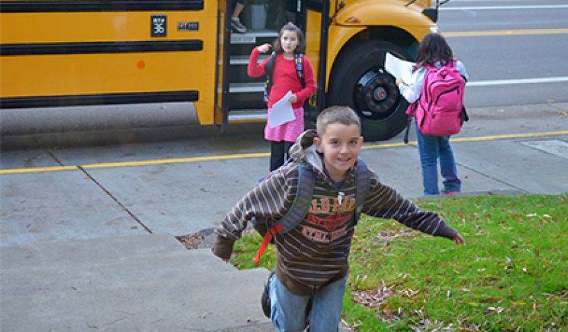 Kids running off a school bus