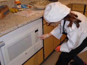 Child setting the timer on a microwave