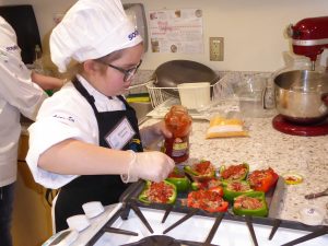 Child stuffing bell peppers