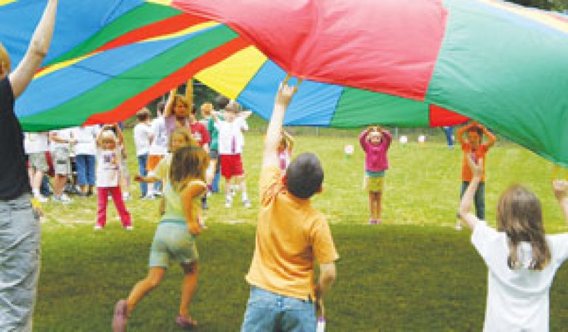 Kids playing with a parachute